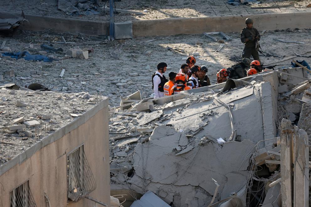 PHOTO: Israeli rescuers search through the rubble at the site of an Iranian missile strike in Bnei Brak, east of Tel Aviv, on June 16, 2025.
