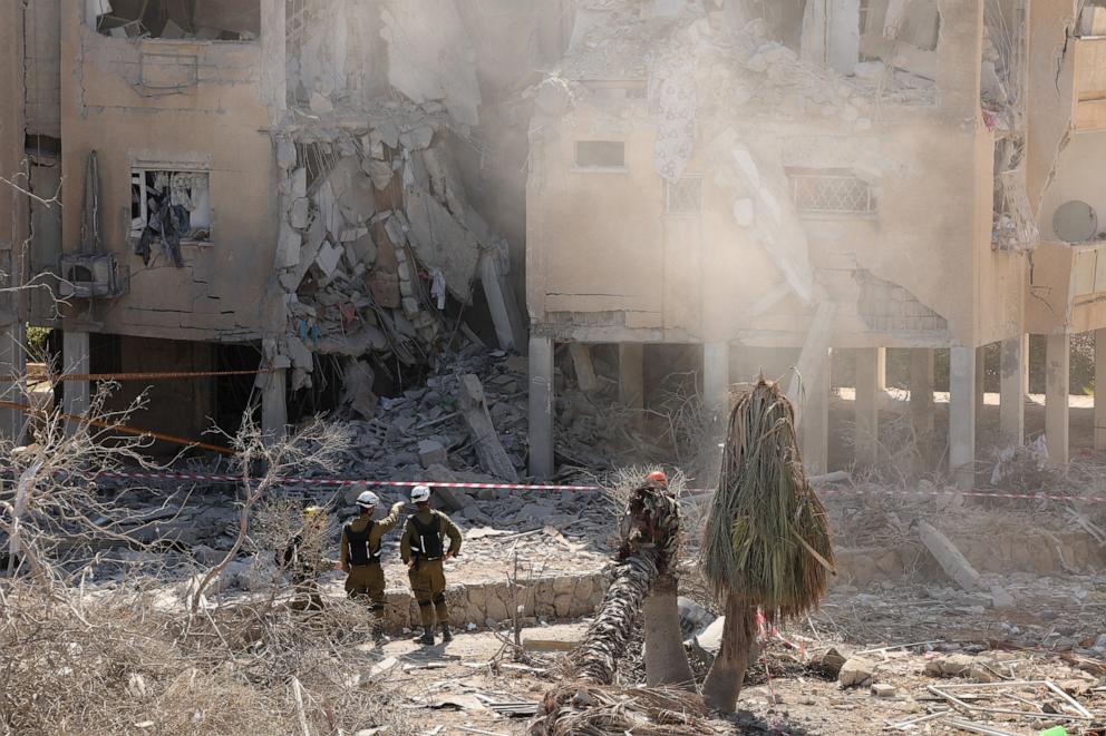 PHOTO: Israeli emergency services check a destroyed building at the site of an Iranian missile attack in a residential area in Holon in central Israel on June 19, 2025.
