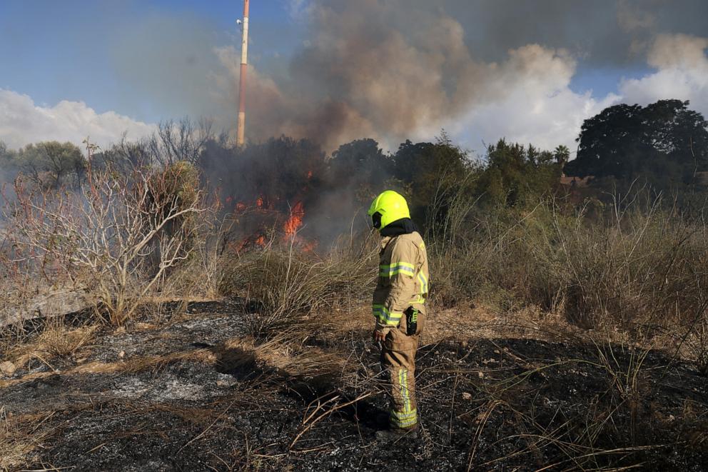 A first responder puts out a fire in an open in Lod near Tel Aviv, reportedly caused by a missile fired from Yemen on September 15, 2024. (Photo by Menahem KAHANA / AFP) (Photo by MENAHEM KAHANA/AFP via Getty Images)