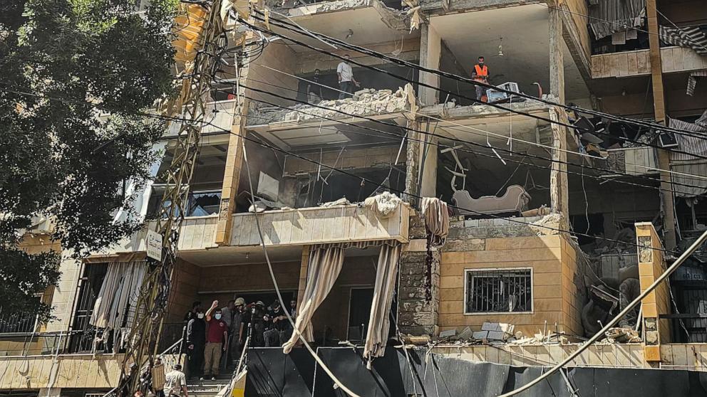PHOTO: First responders inspect damage at the site of an Israeli airstrike on an apartment building in Beirut's southern suburbs, June 7, 2026.