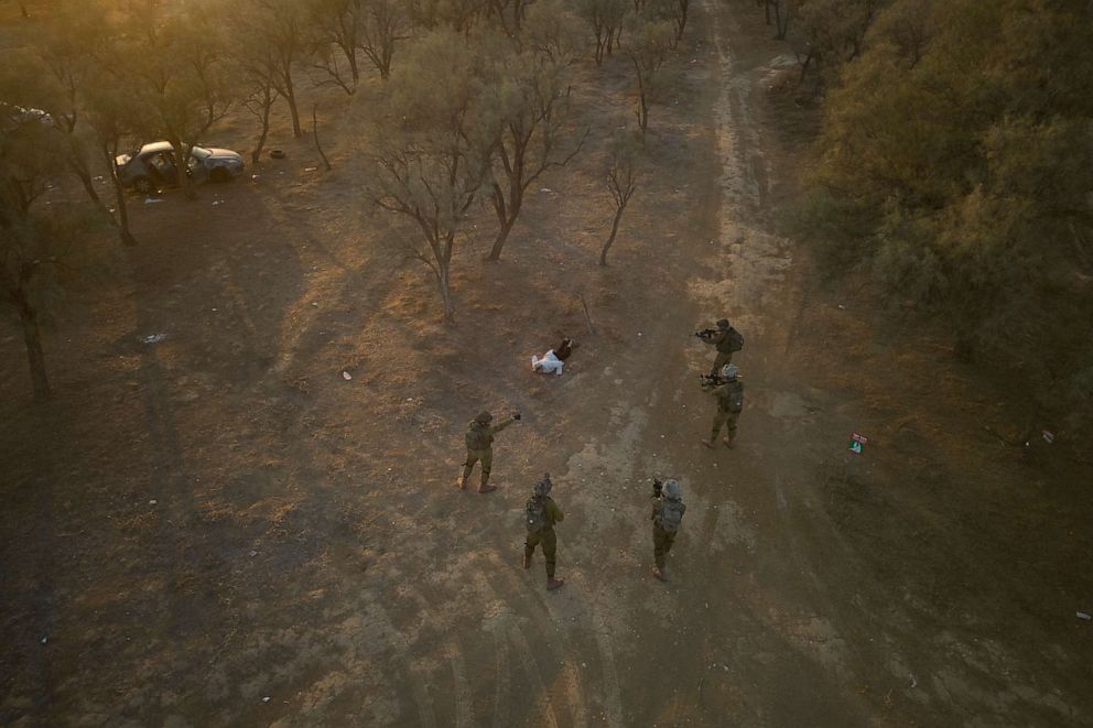 PHOTO: Israeli soldiers surround a Palestinian who ran at them with a knife at the site of a music festival near the border with the Gaza Strip, Oct. 12, 2023.