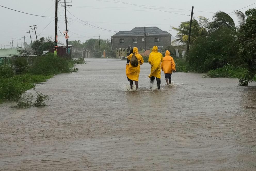 PHOTO: People walk along a road during the passing of Hurricane Melissa in Rocky Point, Jamaica, on Oct. 28, 2025.