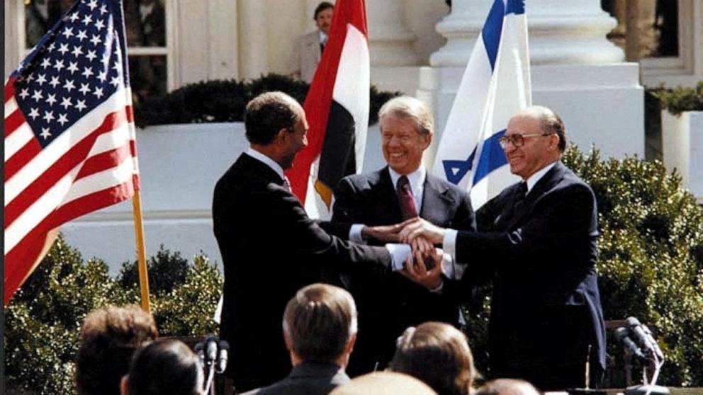 PHOTO: President Jimmy Carter, Egyptian President Anwar Sadat and Israeli Prime Minister Menachem Begin join hands in celebration of the signing of the 1979 Egyptian-Israeli peace treaty at the White House in Washington, D.C., on March 26, 1979.