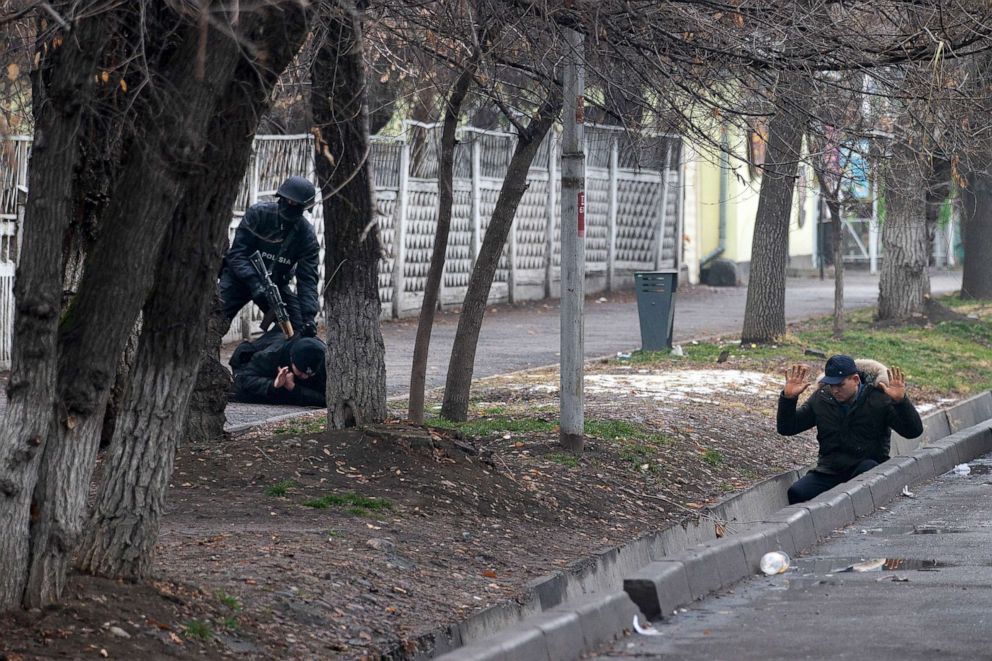 PHOTO: An armed riot police officer detains two protesters during a security anti-terrorists operation in a street after clashes in Almaty, Kazakhstan, Jan. 8, 2022. 