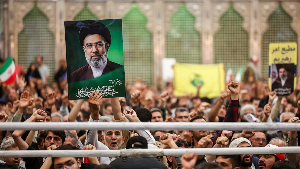 PHOTO: A man holds a placard with an image of Iran's Supreme Leader Mojtaba Khamenei during a ceremony for the 37th anniversary of the death of Ayatollah Ruhollah Khomeini, at Khomeini's shrine in southern Tehran, Iran, on June 4, 2026.