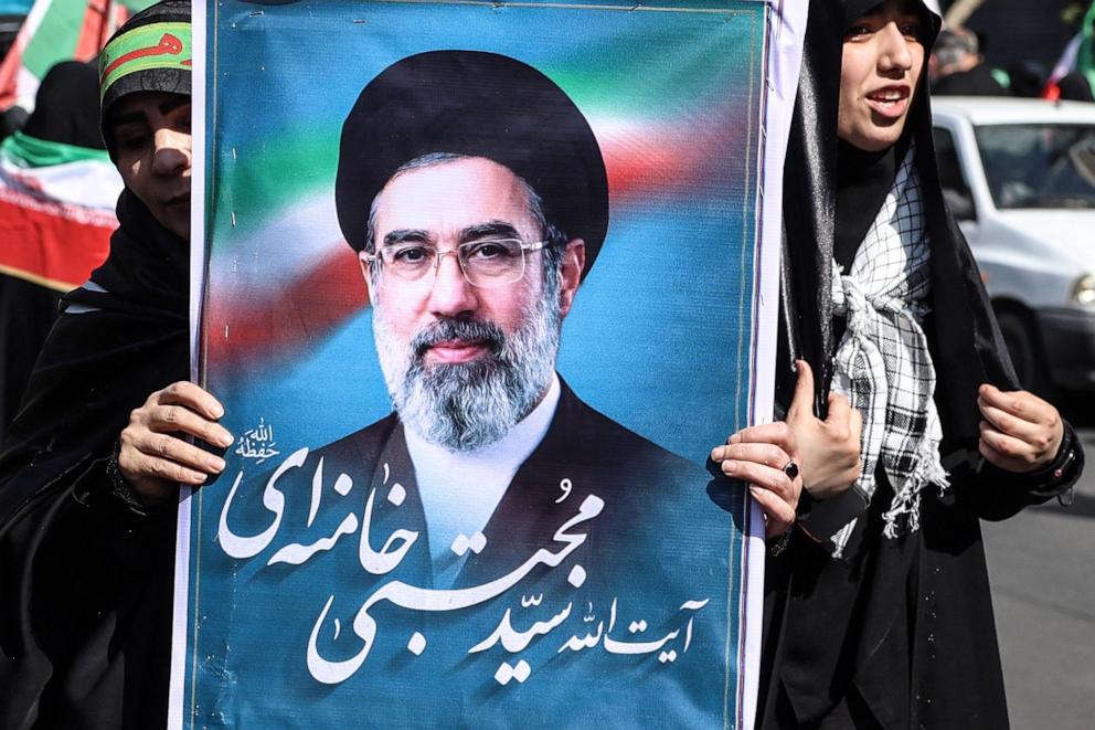 PHOTO: An Iranian woman holds up an image of Iran's new supreme leader Ayatollah Mojtaba Khamenei as she takes part in a rally dubbed "Sacrificed Girls" to pay tribute to women killed during the Middle East war, in Tehran on April 17, 2026.
