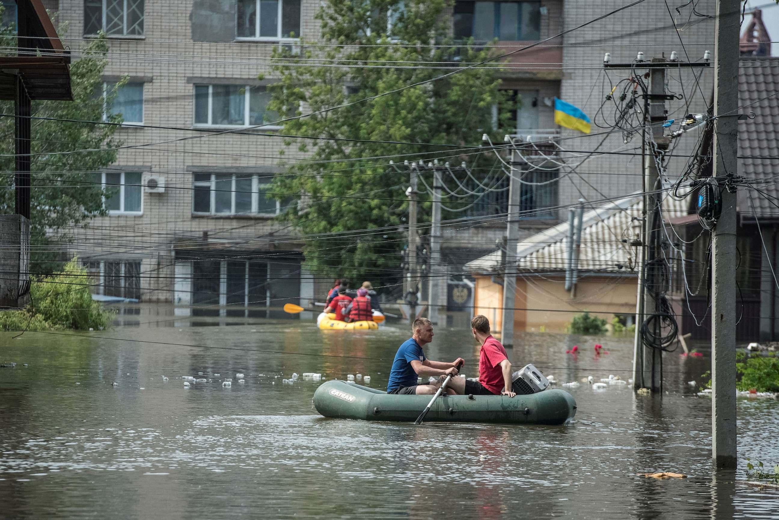 PHOTO: Local residents sail on boats at a flooded street during an evacuation from a flooded area after the Nova Kakhovka dam breached, amid Russia's attack on Ukraine, in Kherson, Ukraine June 8, 2023.