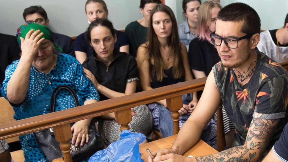 PHOTO: Khudoberdy Nurmatov, who writes for Russian Novaya Gazeta newspaper under the pen name Ali Feruz, right, sits as his mother Zoya Nurmatova, left, gestures in a court room in Moscow, Russia, Aug. 8, 2017.