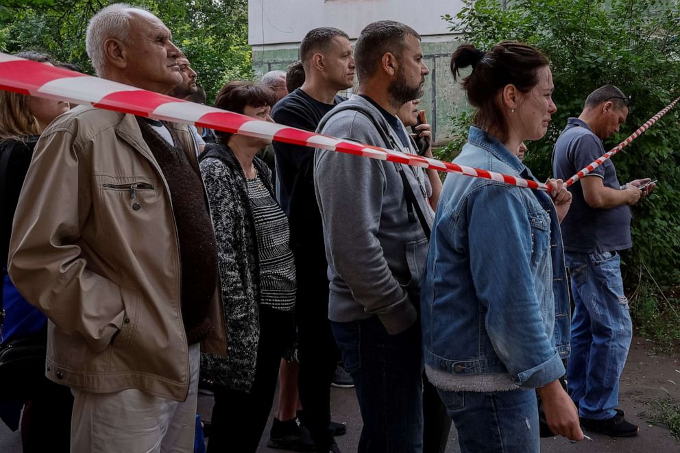 PHOTO: People react at a site of a residential building heavily damaged by a Russian missile strike, amid Russia's attack on Ukraine, in Kryvyi Rih, Dnipropetrovsk region, Ukraine June 13, 2023.