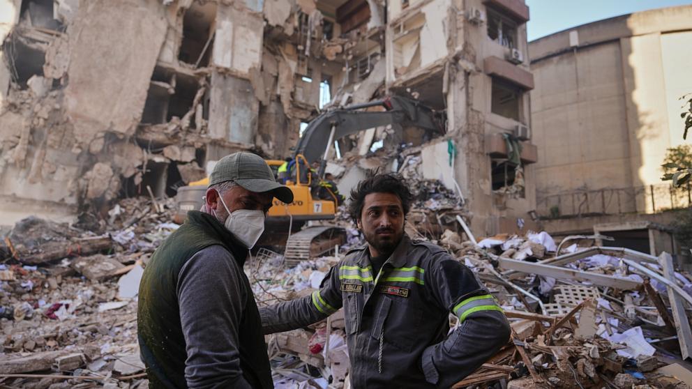 PHOTO: A Lebanese civil defense worker (R) stands with a resident at the site of a building destroyed in an Israeli airstrike a day earlier in central Beirut, Lebanon, on, April 9, 2026.