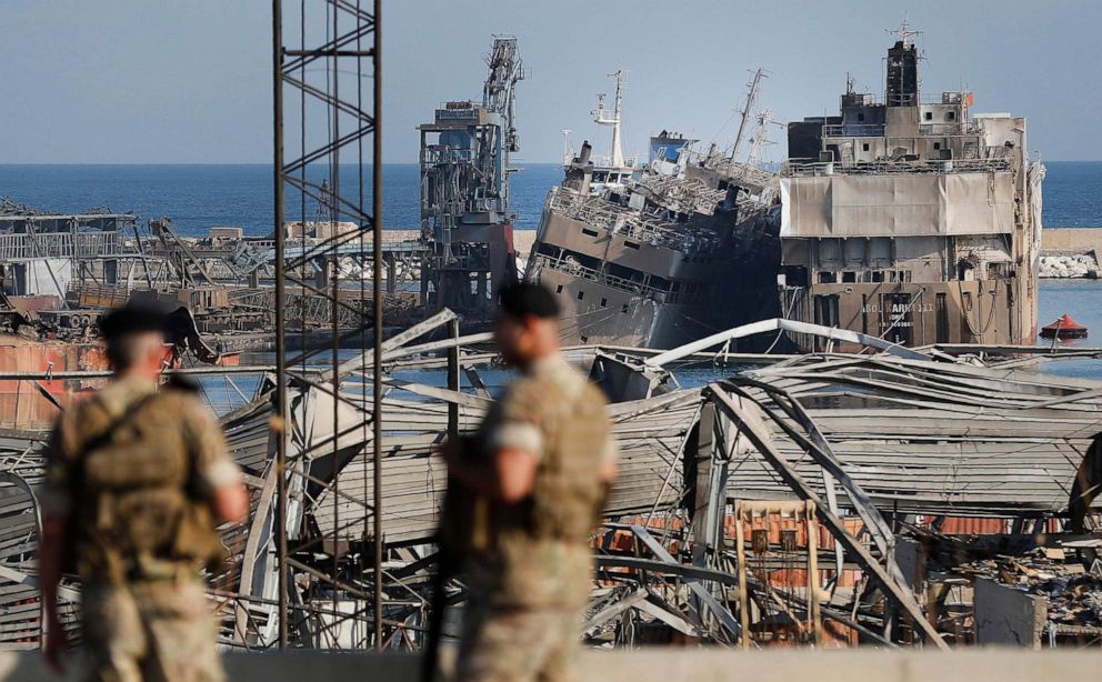 PHOTO: Lebanese army soldiers stand guard in front of destroyed ships at the scene where an explosion hit on Tuesday the seaport of Beirut, Lebanon, Thursday, Aug. 6, 2020. 