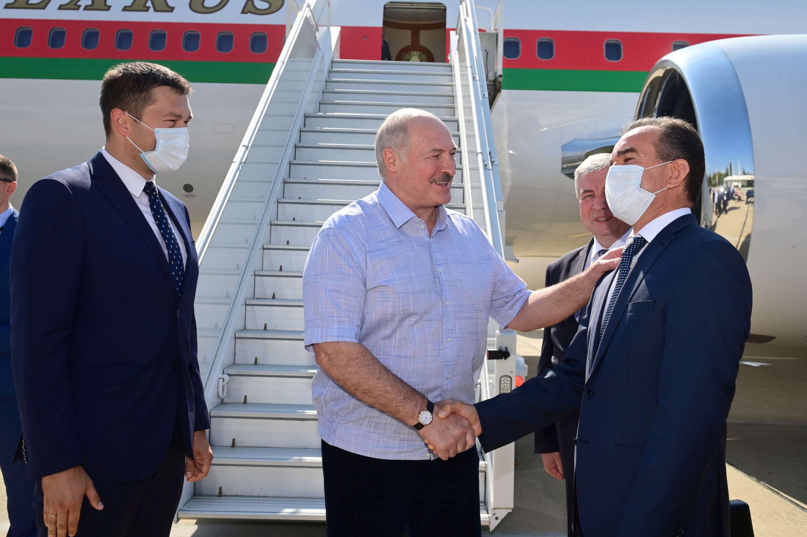 PHOTO: Belarusian President Alexander Lukashenko greets officials during a welcoming ceremony upon his arrival at an airport in Sochi, Russia September 14, 2020.