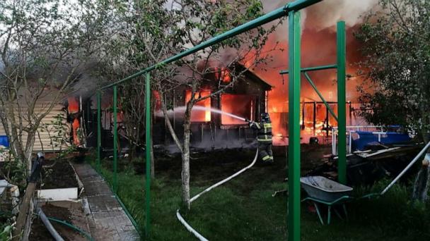 A firefighter works outside a burning house while putting out a fire following what local authorities called a Ukrainian drone attack on a settlement in the Moscow region, Russia, in this picture published May 28, 2025.