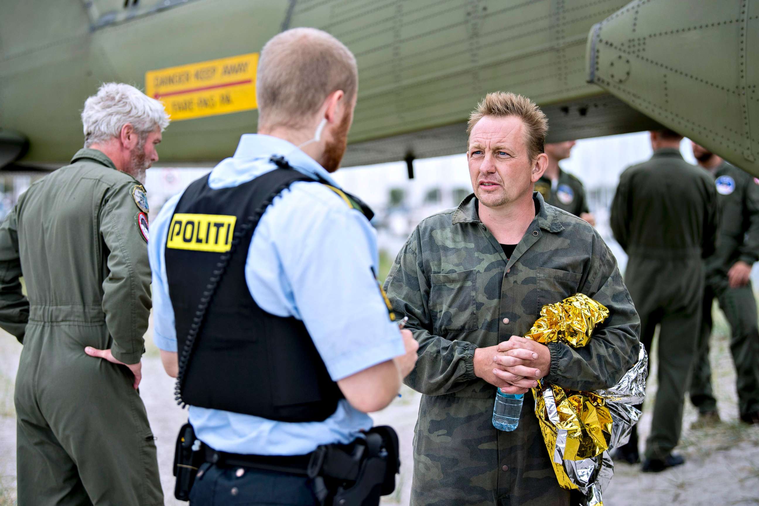 PHOTO: Peter Madsen,right, builder and captain of the private submarine "UC3 Nautilus" as he talks to a police officer in Dragoer Harbor south of Copenhagen on Aug. 11, 2017.
