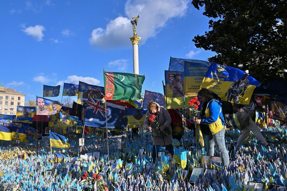 PHOTO: Women lay flowers in tribute to fallen Ukrainian soldiers at a makeshift memorial at Independence Square in Kyiv, on Nov. 2, 2024.