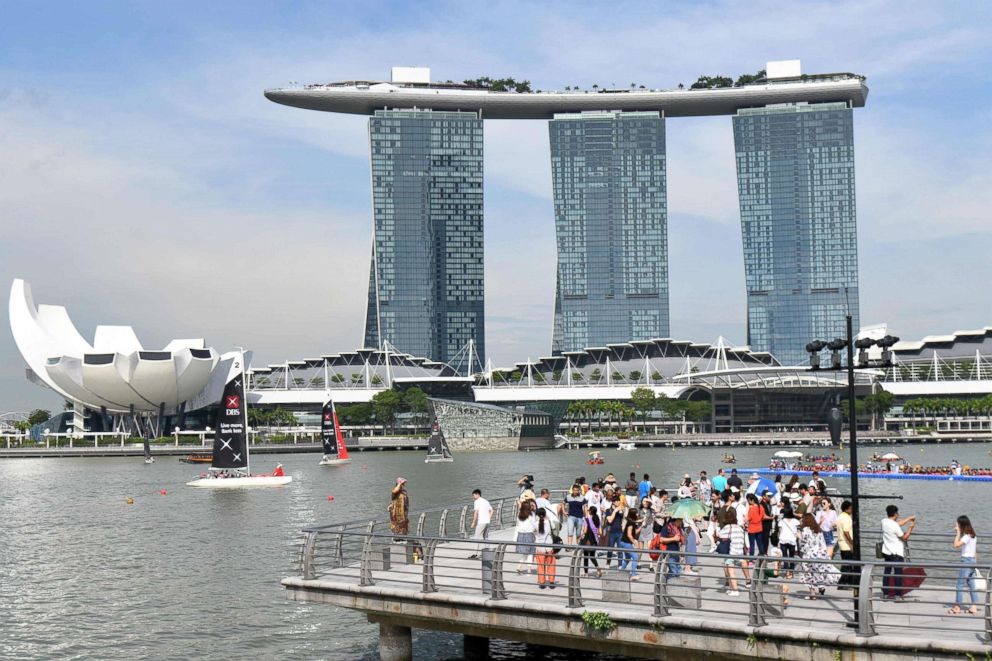 PHOTO: People view the Marina Bay Sands hotel and resort from the Merlion Park on May 27, 2018 in Singapore.