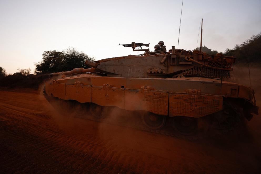 PHOTO: Israeli soldiers ride a Merkava main battle tank at a position in northern Israel along the border with southern Lebanon on Nov. 6, 2025.