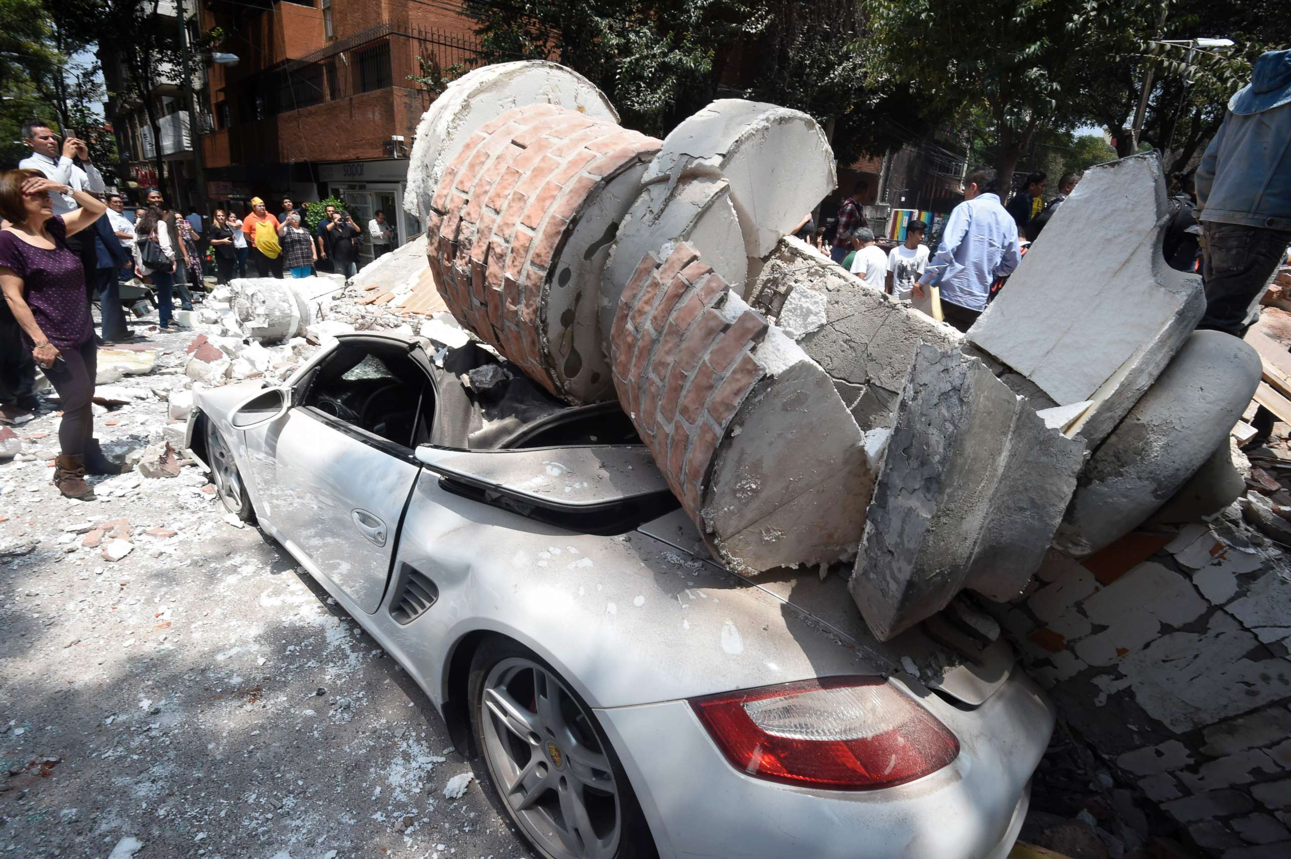 PHOTO: A car parked on the street in Mexico City sits under debris from a damaged building after a 7.1 earthquake rattled Mexico City on September 19, 2017.