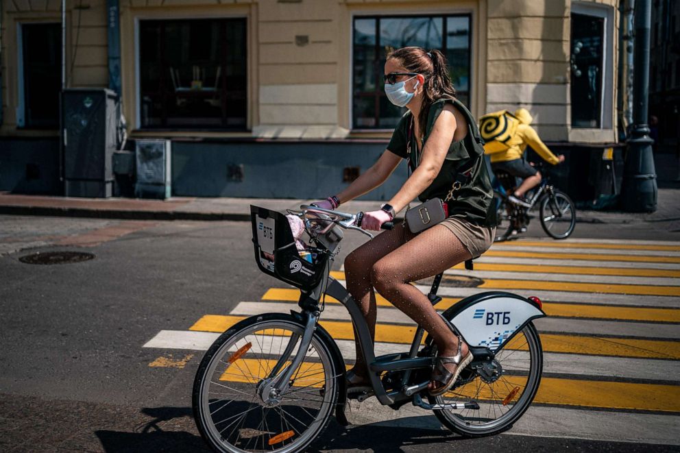 PHOTO: A woman cycles in downtown Moscow on June 9, 2020, on the first day after Moscow lifted a range of anti-coronavirus measures including a strict lockdown set up to curb the spread of the COVID-19 caused by the novel coronavirus. 