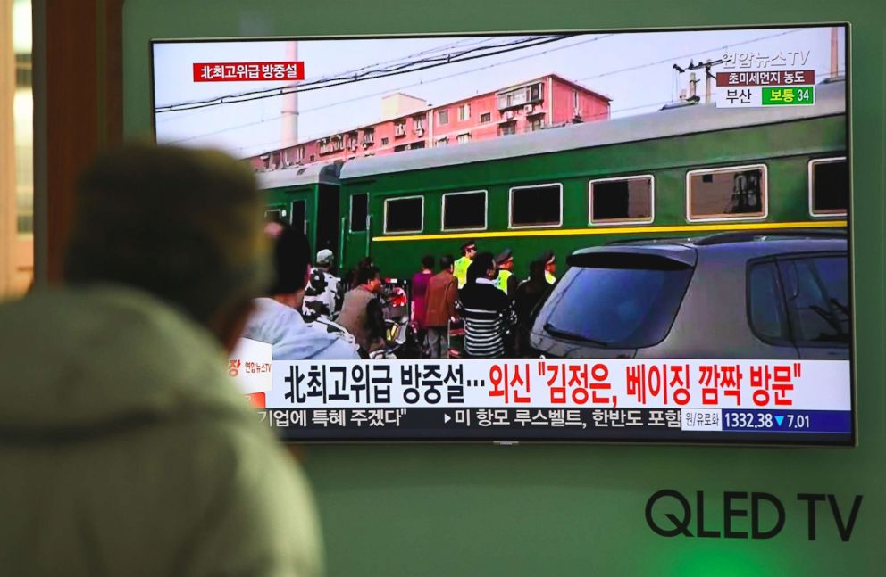 PHOTO: A man watches a television news report about a suspected visit to China by North Korean leader Kim Jong Un, at a railway station in Seoul on March 27, 2018.