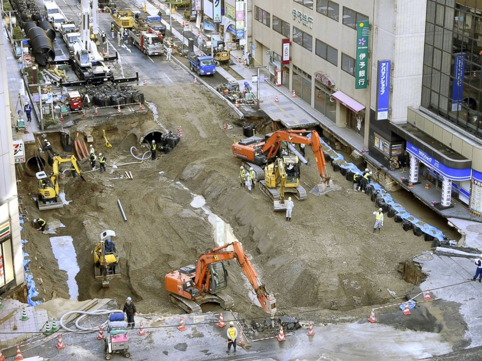 PHOTO: Work continues to fill a huge sinkhole, believed to have been caused by subway construction, beneath a major road near JR Hakata Station in the southwestern Japan city of Fukuoka on Nov. 11, 2016. 