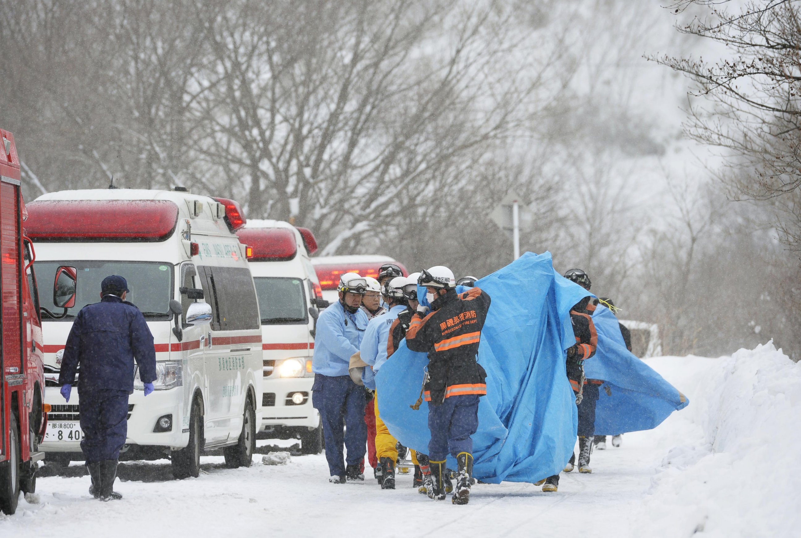 PHOTO: Rescuers carry people injured in an avalanche near a ski slope north of Tokyo, Japan, March 27, 2017. 