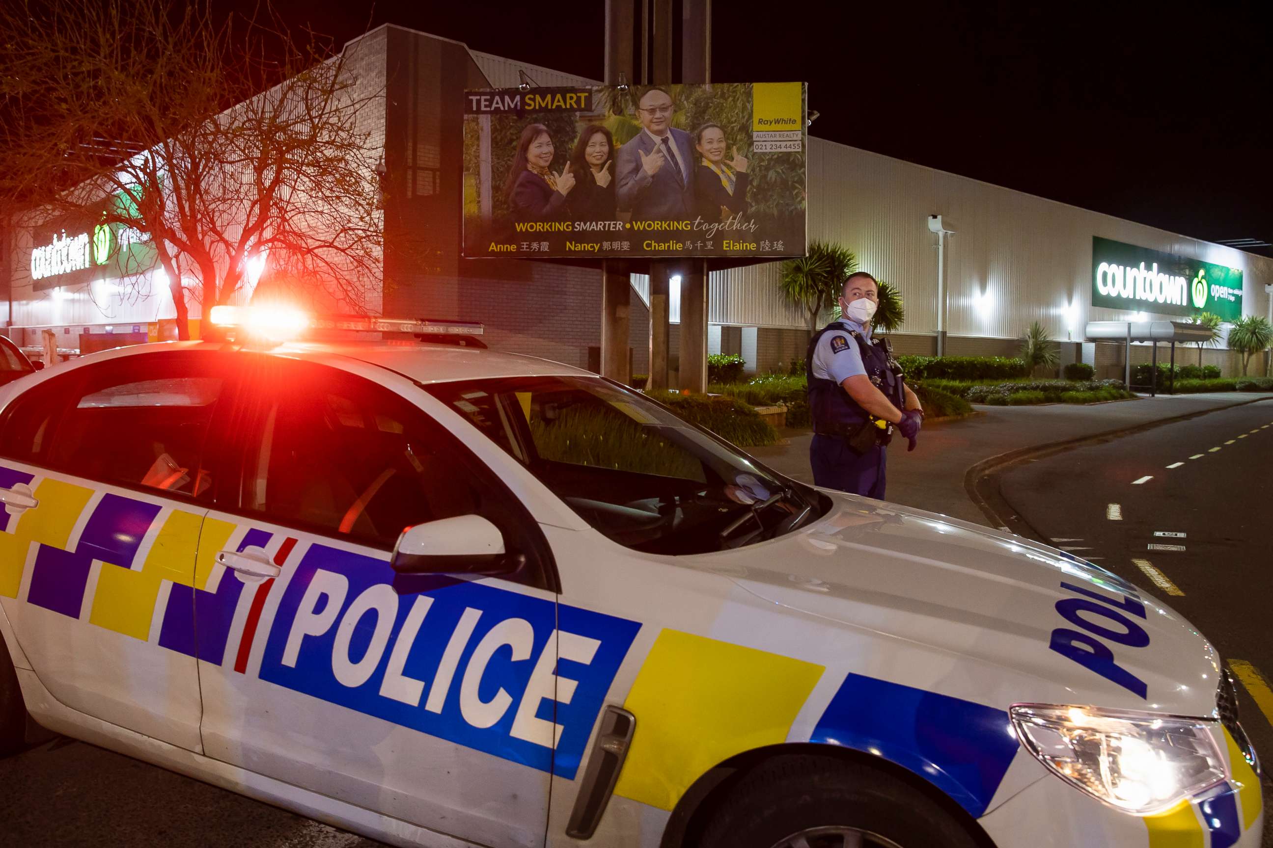 PHOTO: Police stand outside the site of a knife attack at a supermarket in Auckland, New Zealand, Friday, Sept. 3, 2021. Authorities say they shot and killed a violent extremist after he entered the supermarket and stabbed and injured six shoppers. 