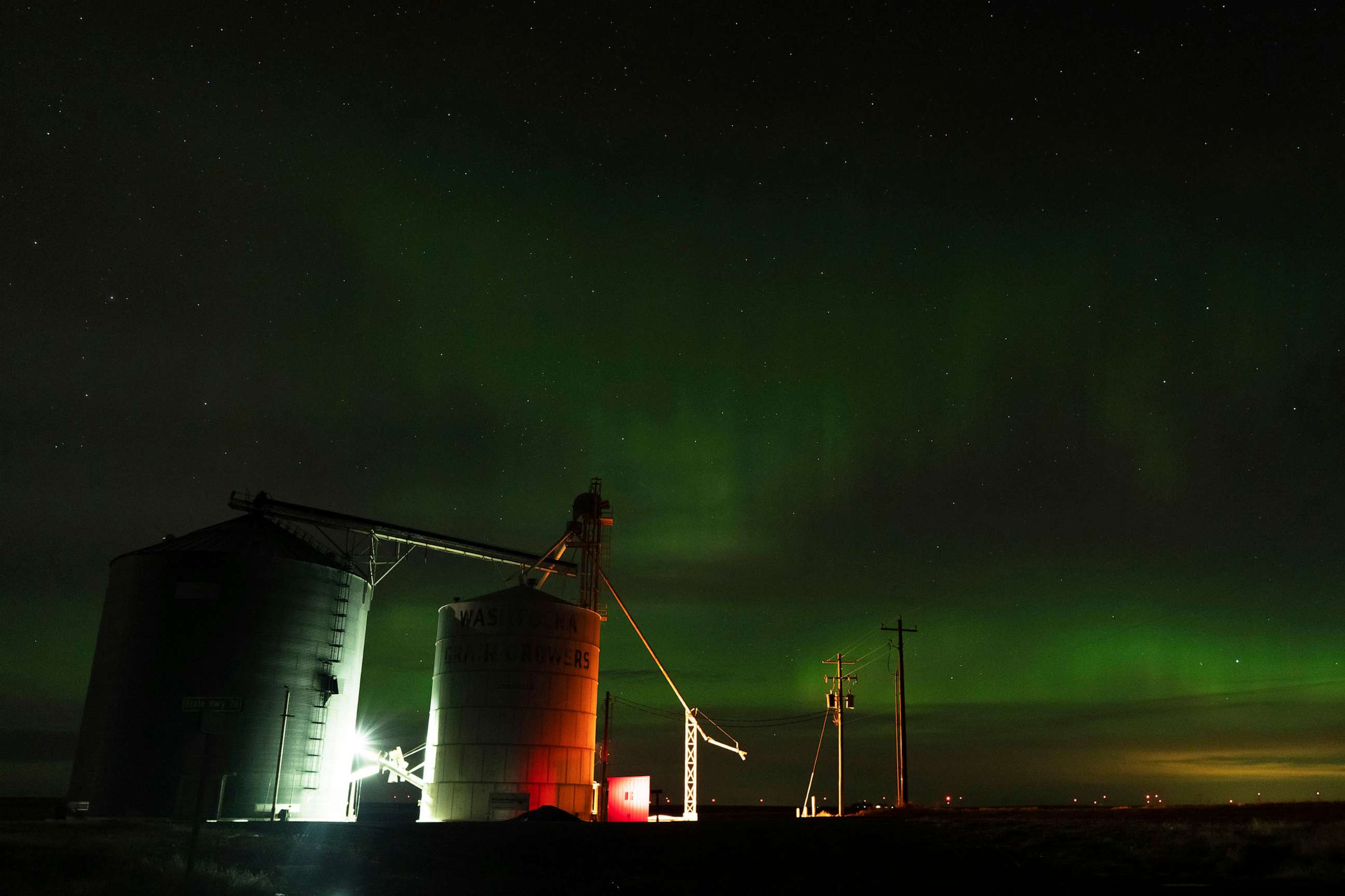 PHOTO: An aurora borealis, also known as the northern lights, is seen in the night sky, Feb. 26, 2023, next to grain elevators near Washtucna, Wash.