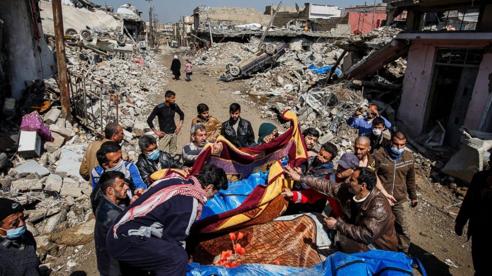 Residents pile up body bags in the back of a pick up truck after recovering it from the rubble where there were reported coalition air strikes in the Mosul al-Jadida neighborhood of Mosul, March 24, 2017. The U.S. military is investigating whether it was responsible for the bombing raid, the most deadly among Iraqi residents since the battle against the militant group Islamic State began more than two years ago.