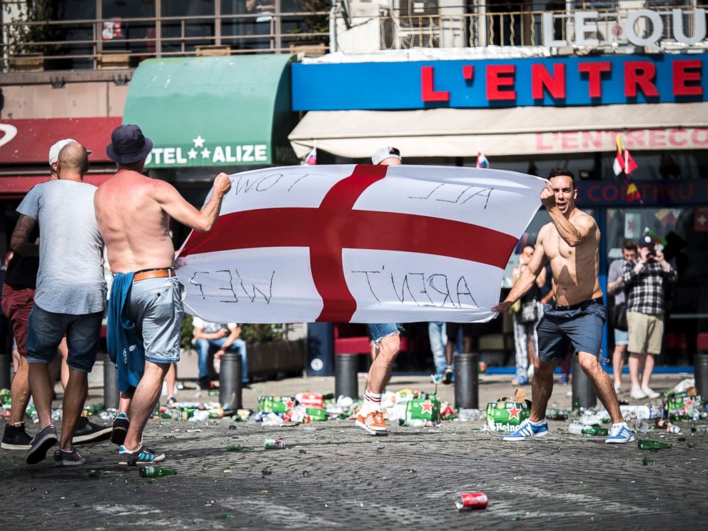 PHOTO: English supporters throw glass bottles as they clash with riot police at the Old Port of Marseille, France, June 11, 2016, before the UEFA EURO 2016 group B preliminary round match between England and Russia.