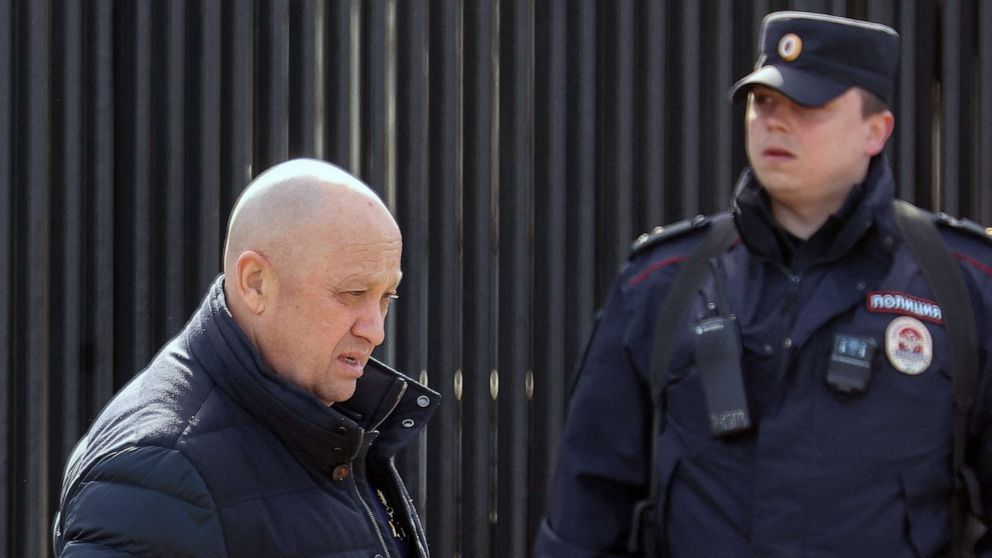 PHOTO: Founder of Wagner private mercenary group Yevgeny Prigozhin walks past a police officer in Moscow, April 8, 2023.