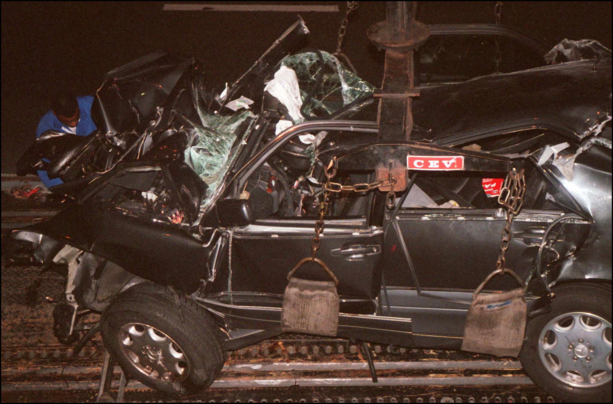 PHOTO: Emergency crews work on the wreckage of Princess Diana's car in the Alma tunnel of Paris.