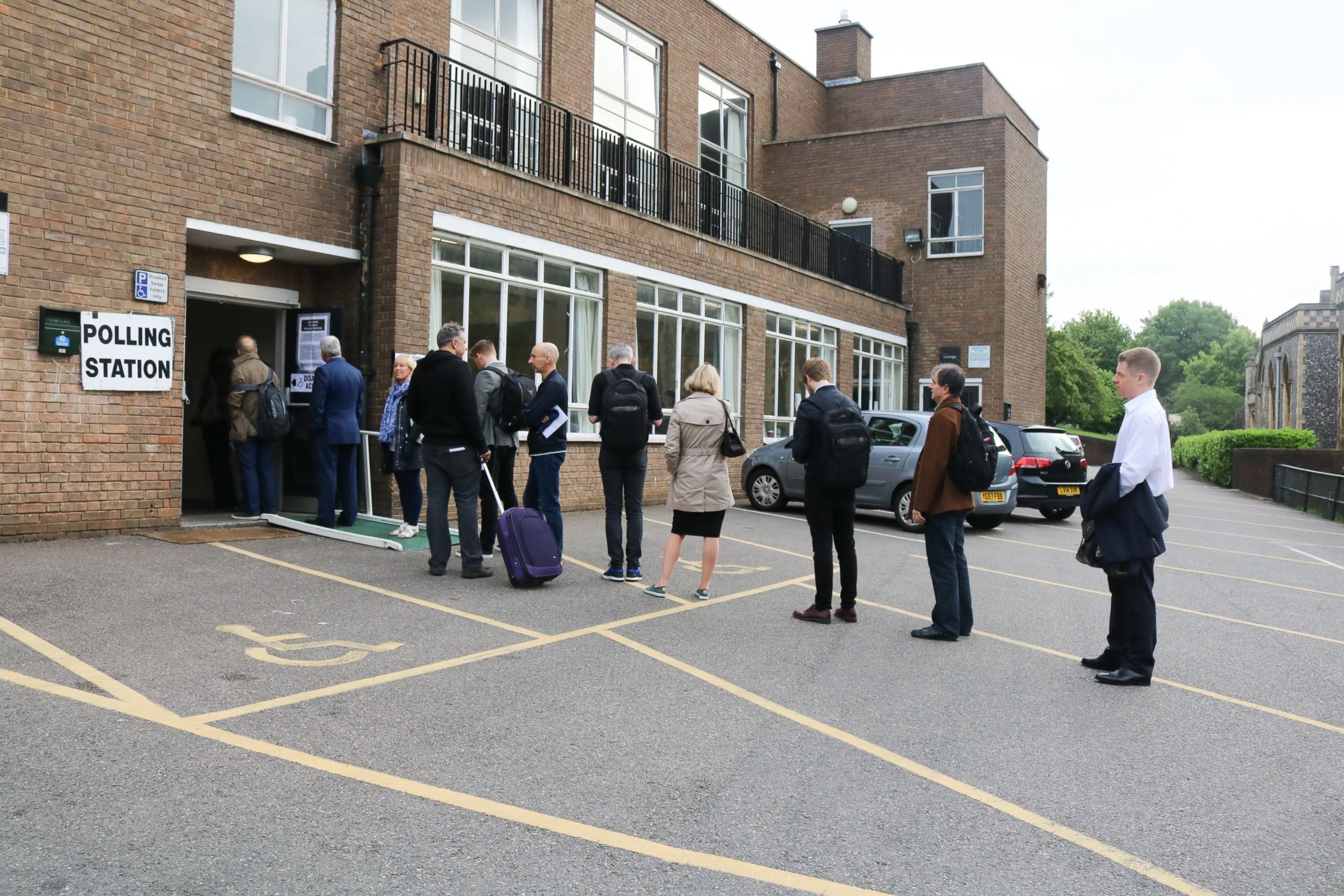 PHOTO: Voters line up at the polling station in Sacred Heart church Wimbledon to cast their vote at the general election, June 8, 2017, in London.
