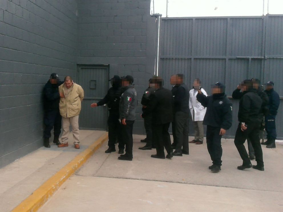 PHOTO: Mexicos top drug lord Joaquin El Chapo Guzman (2nd L) is escorted by police officers in Ciudad Juarez, Mexico, as he is extradited to New York in this handout image made available January 19, 2017.