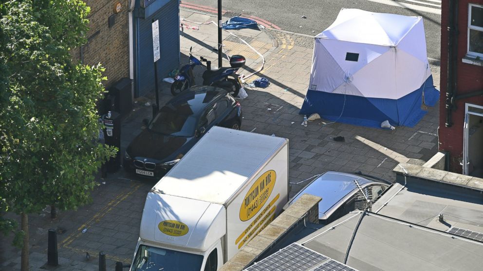 PHOTO: British forensic experts stand next to the van and a forensic tent in Finsbury Park, after a van hit worshipers in north London, June 19, 2017.