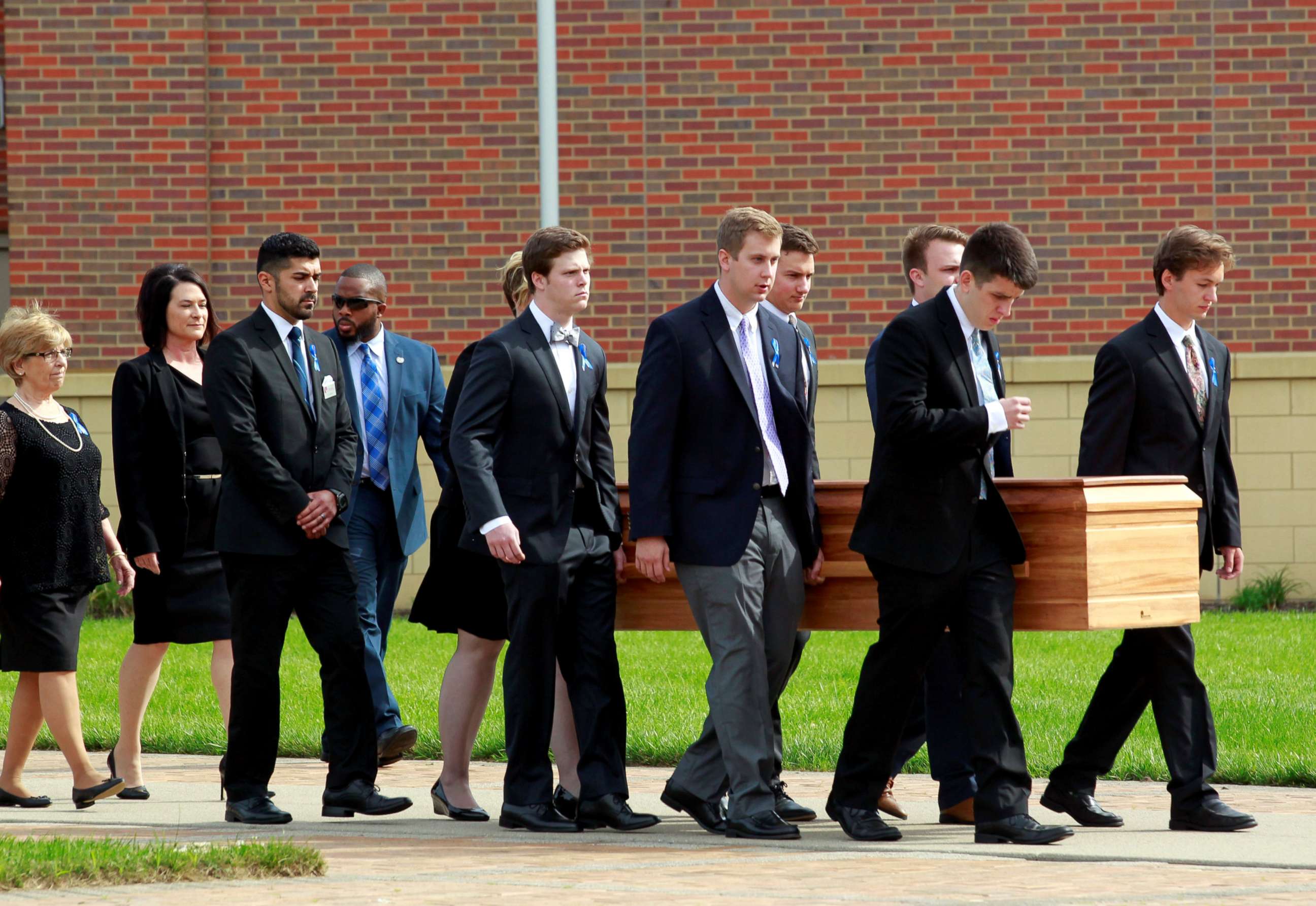 PHOTO: Otto Warmbier's casket is carried to the hearse followed by his family and friends after a funeral service for Warmbier, who died after his release from North Korea detention in a coma, at Wyoming High School in Wyoming, Ohio, June 22, 2017.  