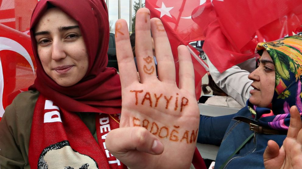A woman shows the name of Turkey's president written on her palm as she waits for the arrival of President Tayyip Erdogan at Esenboga Airport, April 17, 2017, in Ankara, Turkey.