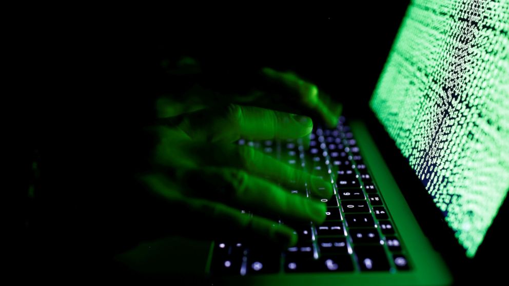 A man types on a computer keyboard in front of the displayed cyber code in this illustration picture taken on March 1, 2017. 