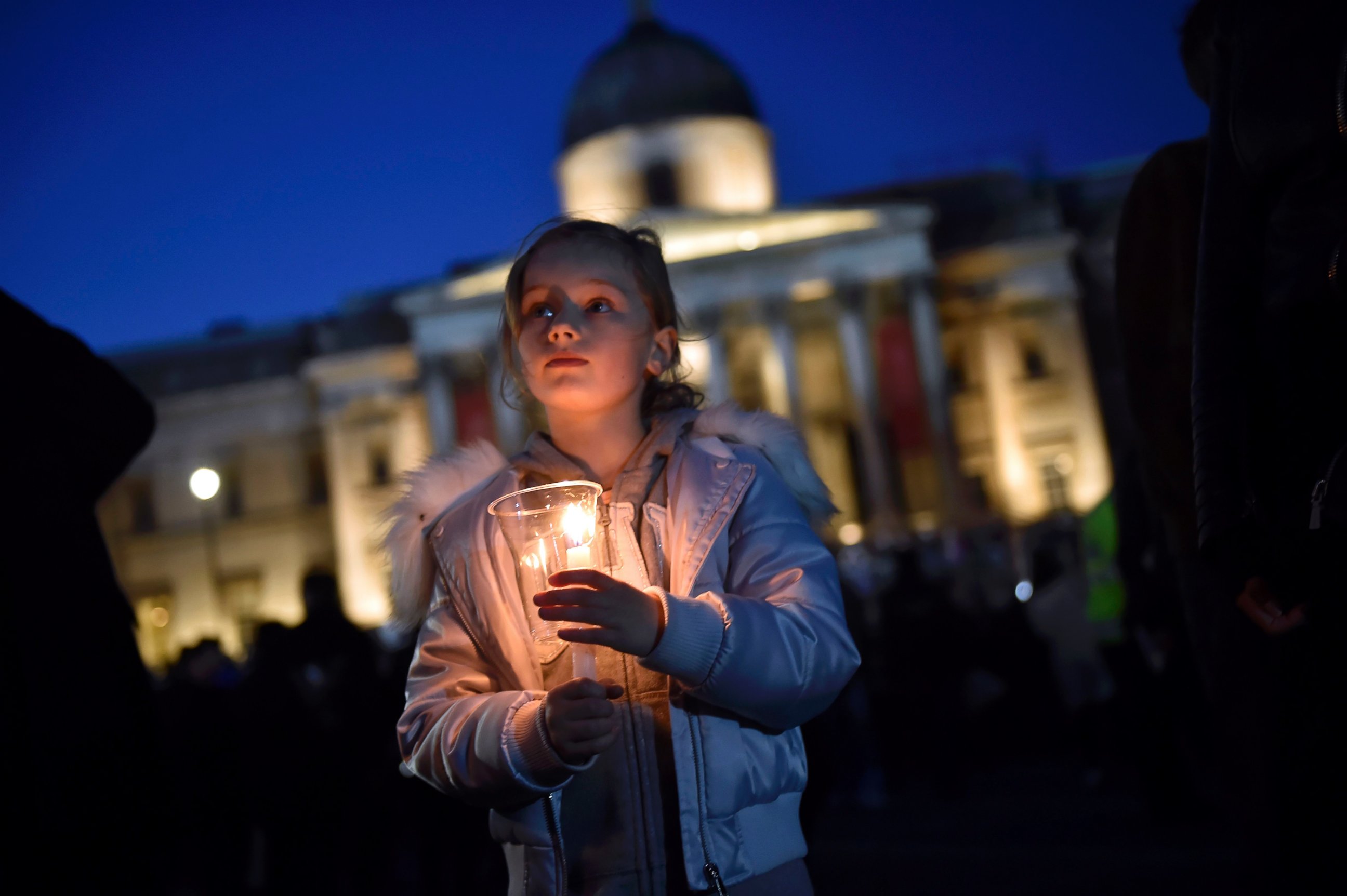 PHOTO: People light candles at a vigil in Trafalgar Square the day after an attack, in London, March 23, 2017.  