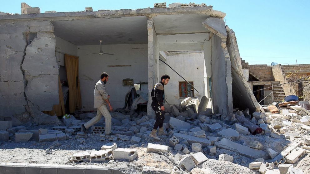 PHOTO: Civil defense members inspect the damage at a site hit by airstrikes in the town of Khan Sheikhoun in rebel-held Idlib, Syria, April 5, 2017. 