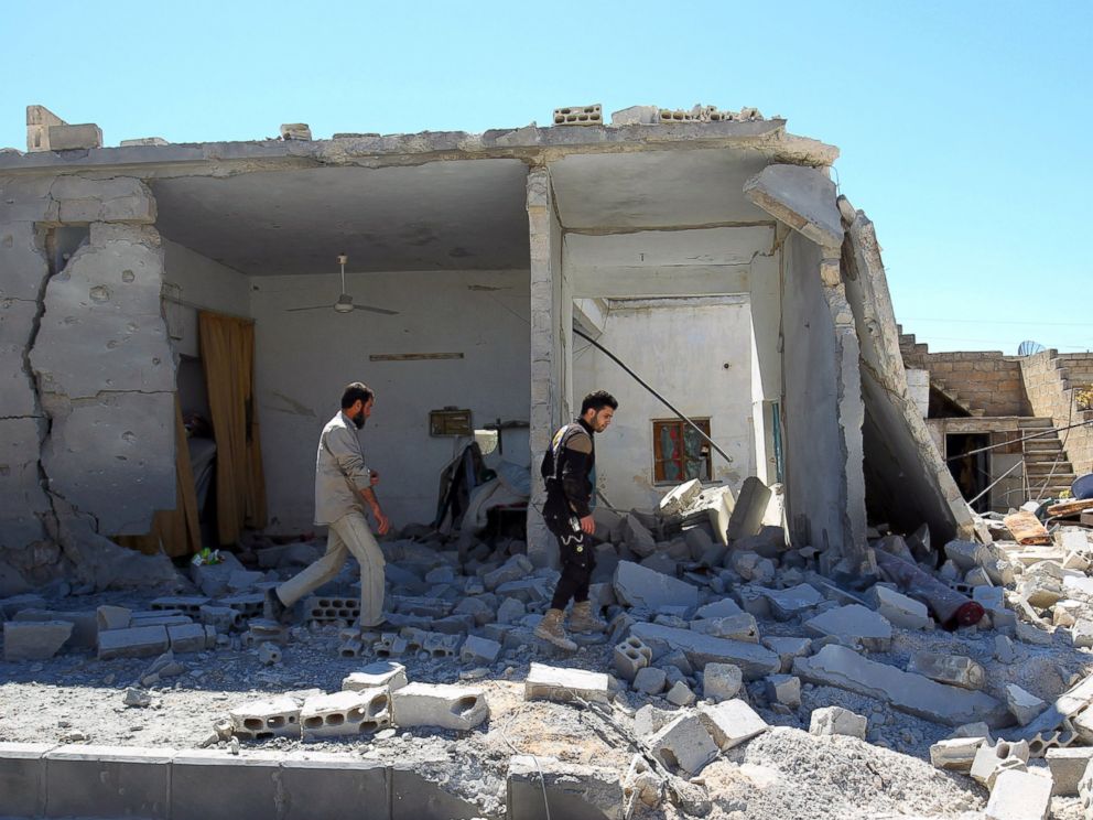 PHOTO: Civil defense members inspect the damage at a site hit by airstrikes in the town of Khan Sheikhoun in rebel-held Idlib, Syria, April 5, 2017.