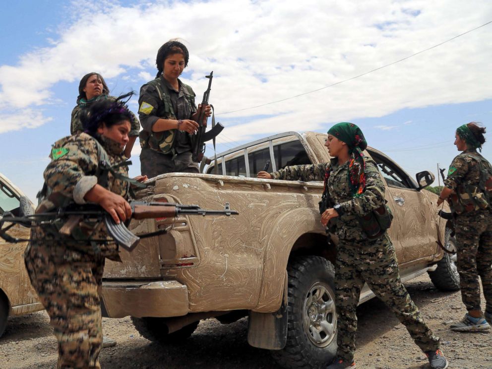 PHOTO: Members of the Syrian Democratic Forces (SDF), made up of an alliance of Kurdish and Arab fighters, take position a neighborhood on the eastern front of ISISs Syrian bastion of Raqqa after seizing the area from the jihadists, June 14, 2017.