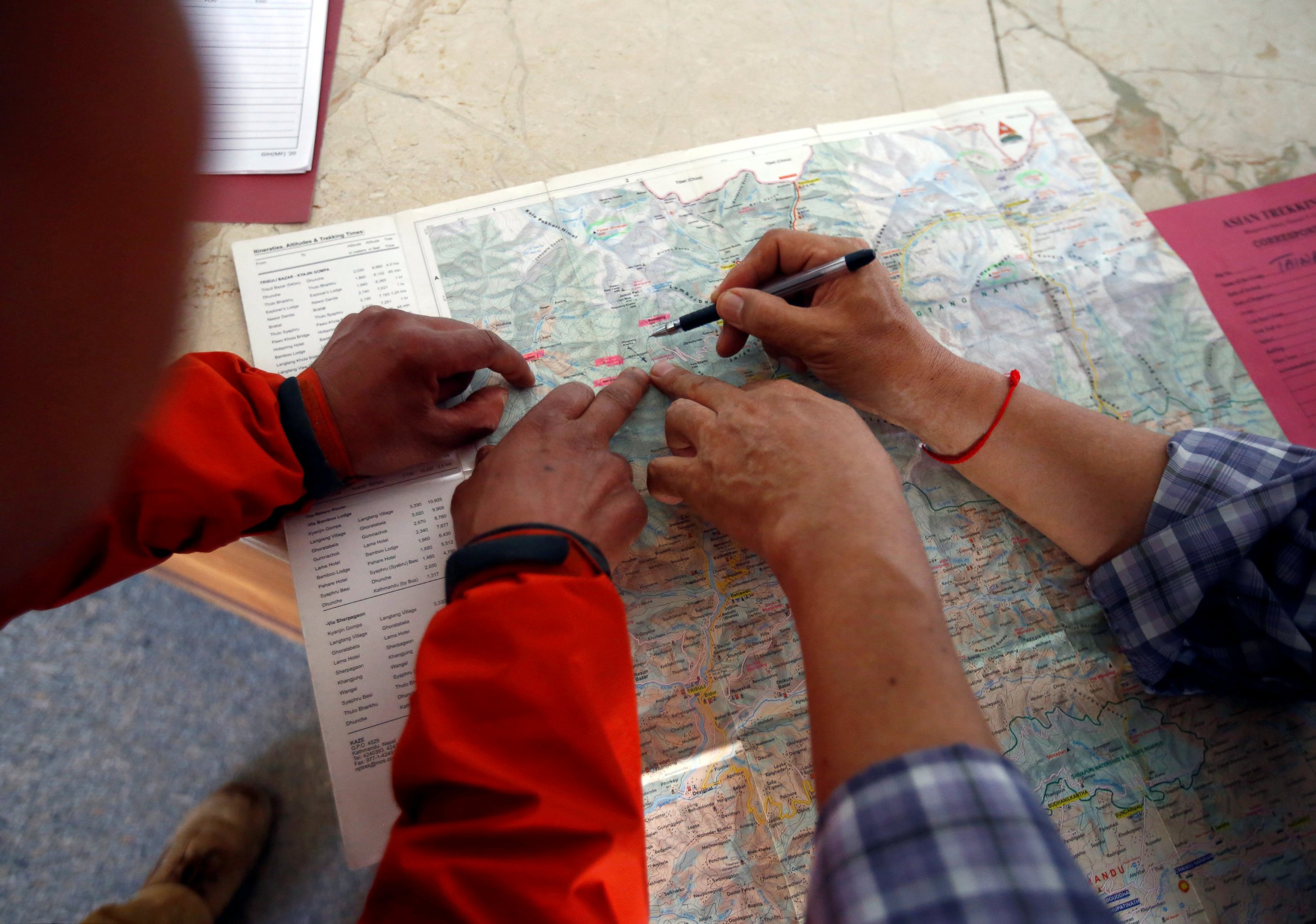 PHOTO: Rescue personnel from Asian Trekking shows the place on the map where Liang Sheng Yueh and Liu Chen Chun were found, in Kathmandu, Nepal, April 26, 2017.
