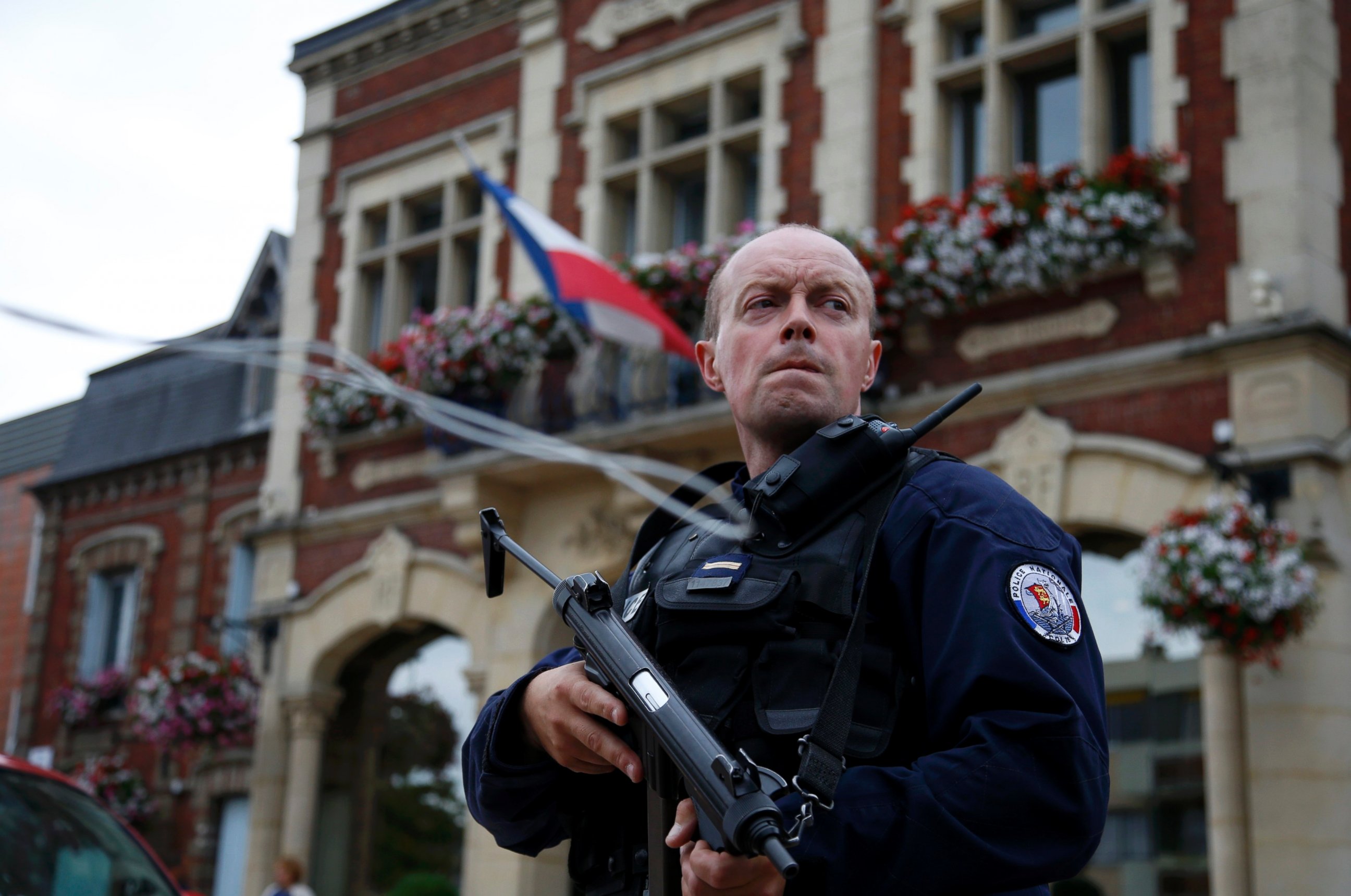 PHOTO: A policeman secures a position in front of the city hall after two assailants had taken five people hostage in the church at Saint-Etienne-du-Rouvray near Rouen in Normandy, France, July 26, 2016. 