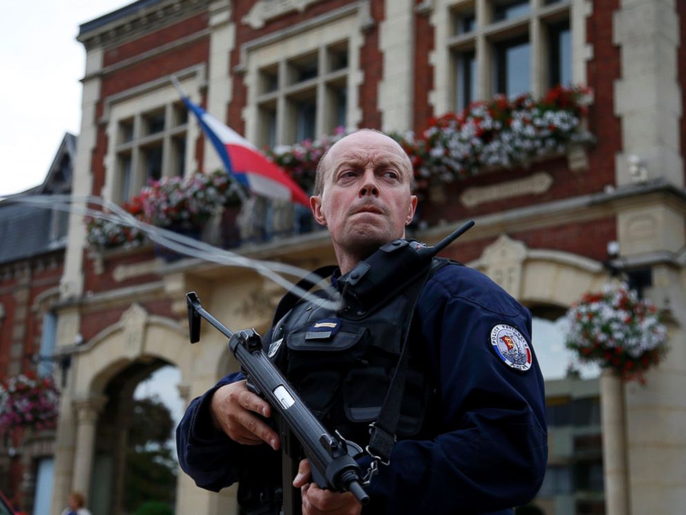PHOTO: A policeman secures a position in front of the city hall after two assailants had taken five people hostage in the church at Saint-Etienne-du-Rouvray near Rouen in Normandy, France, July 26, 2016.