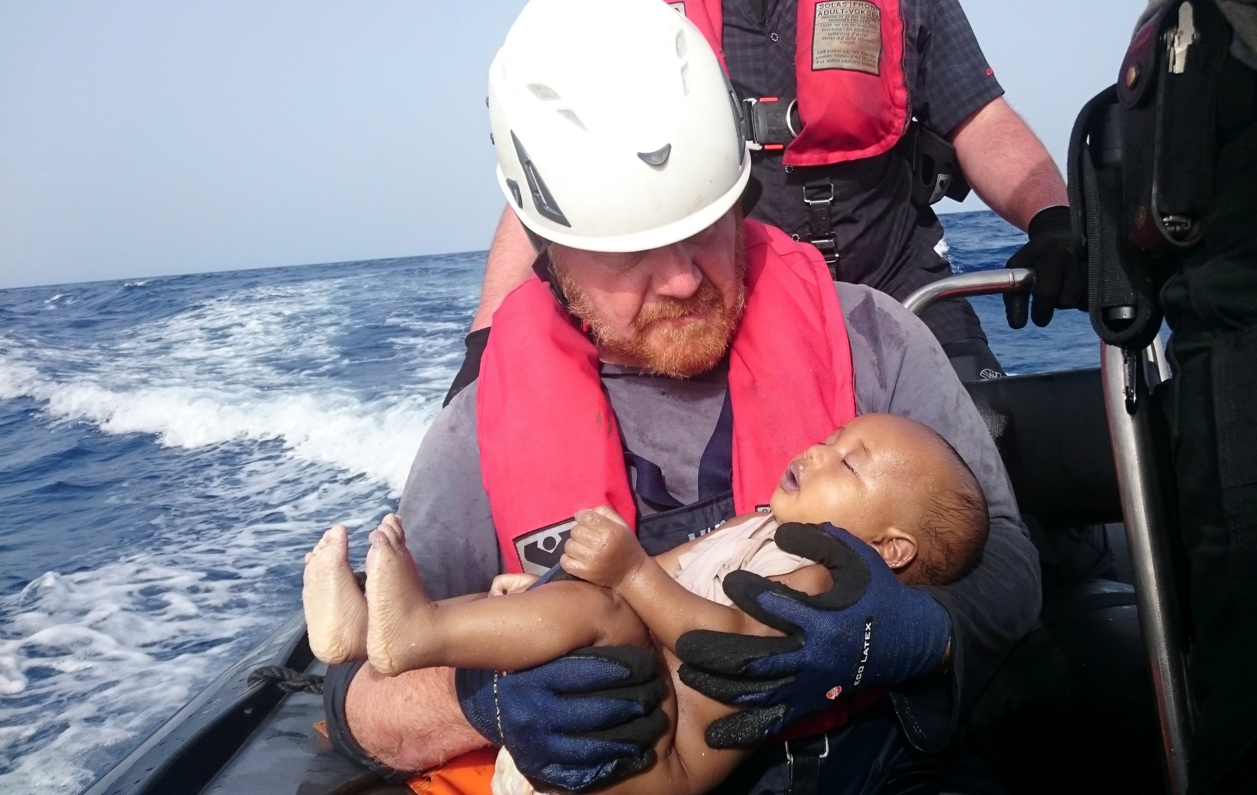 PHOTO: German rescuer from the humanitarian organization Sea-Watch holds a drowned migrant baby, off the Libyan coast on May 27, 2016. 