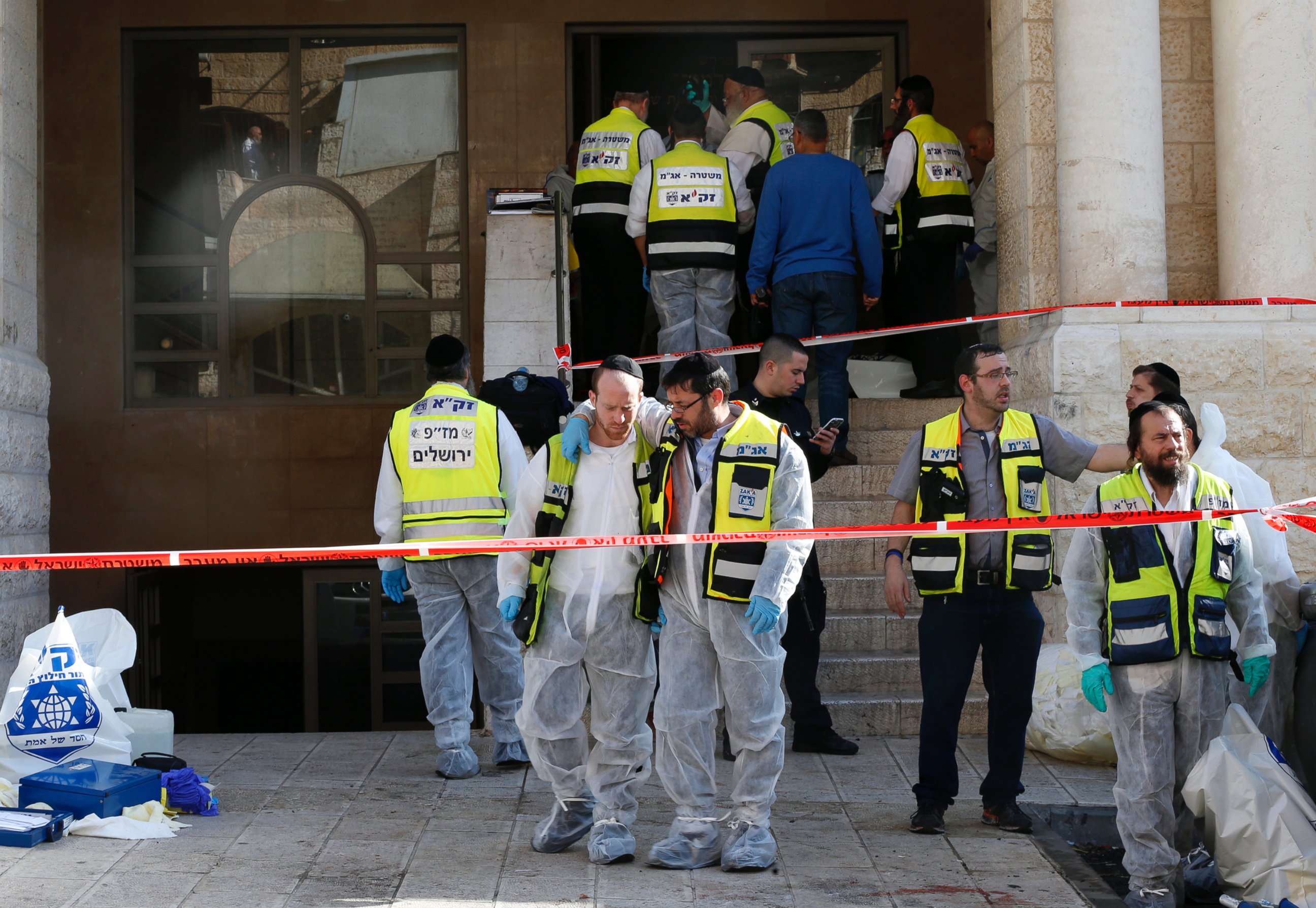 PHOTO: Israeli emergency personnel stand at the scene of an attack at a Jerusalem synagogue Nov. 18, 2014.