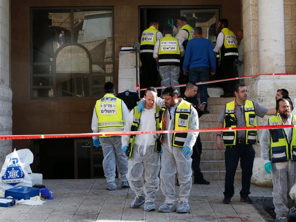 PHOTO: Israeli emergency personnel stand at the scene of an attack at a Jerusalem synagogue Nov. 18, 2014.