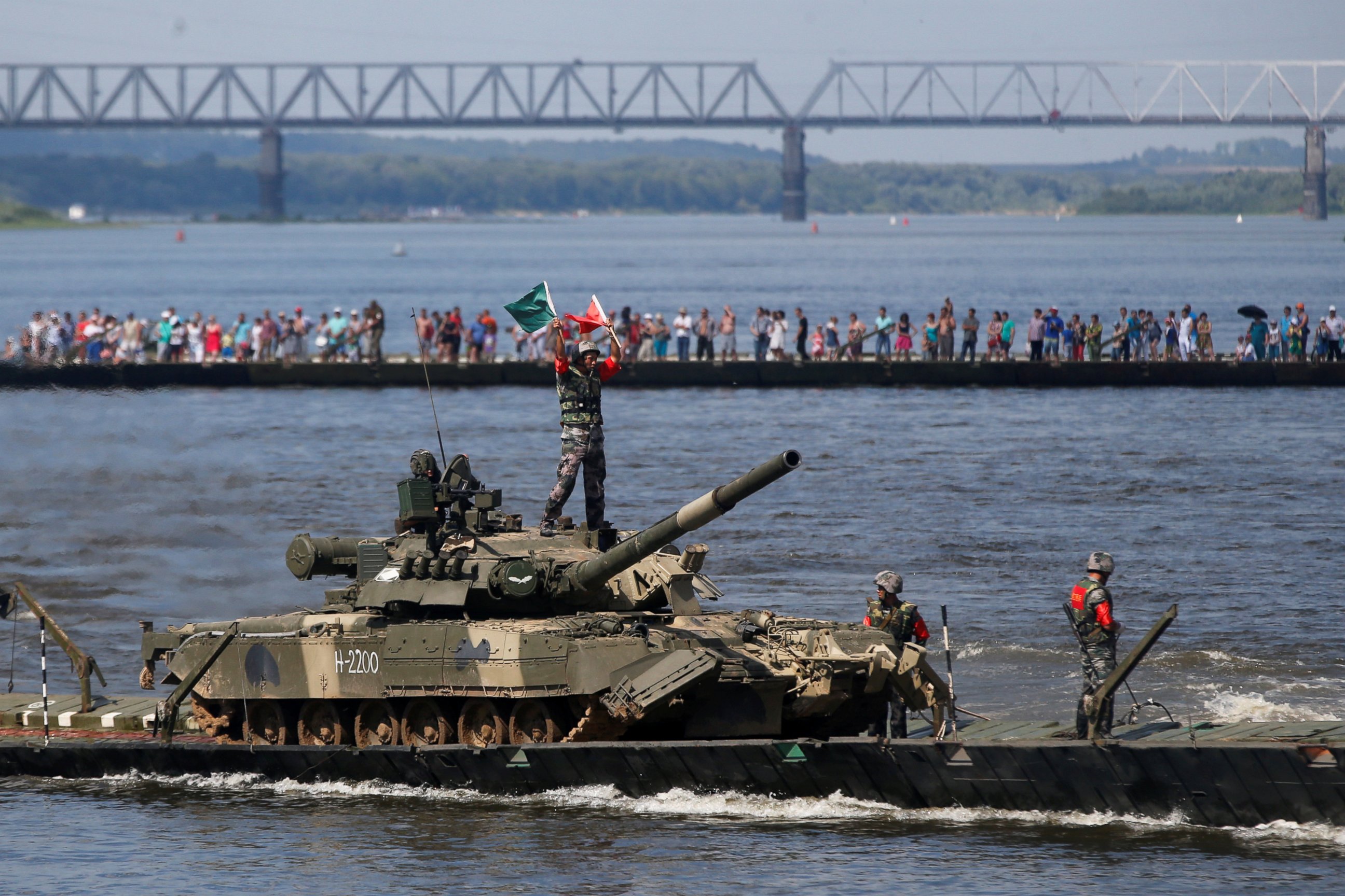 PHOTO:Chinese crew members transport a T-80 tank on a pontoon bridge during the Open Water competition for pontoon bridge units, part of the International Army Games 2016, in the city of Murom, Russia, on Aug. 6, 2016. 