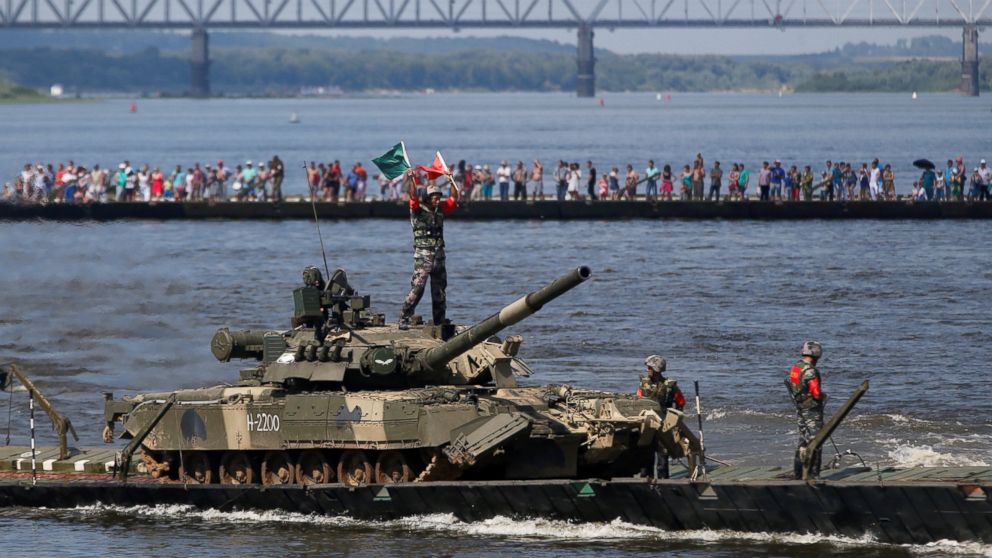 PHOTO:Chinese crew members transport a T-80 tank on a pontoon bridge during the Open Water competition for pontoon bridge units, part of the International Army Games 2016, in the city of Murom, Russia, on Aug. 6, 2016. 